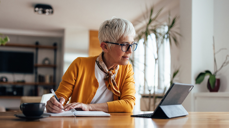 older woman browsing her tablet to open an account